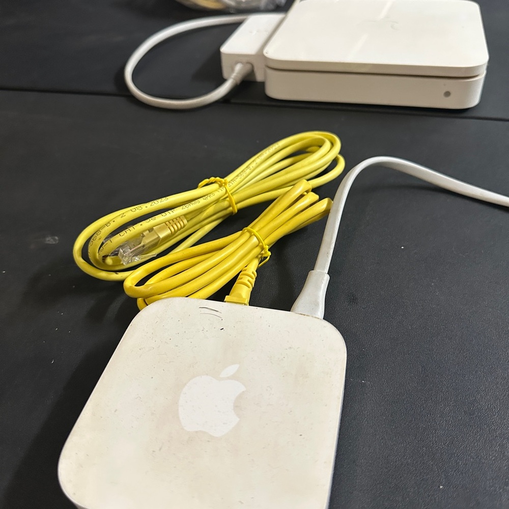 Apple White Router with Yellow Cable